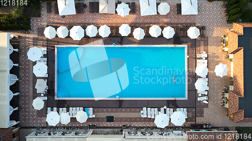 Image of Aerial view on people in swimming pool. Top view of people sunbathing pool.