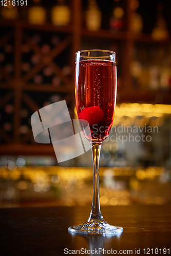 Image of Red Cocktail in Champagne Glass near in the Bar with Amazing Blurred Background.