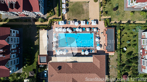 Image of Aerial view on people in swimming pool. Top view of people sunbathing pool.