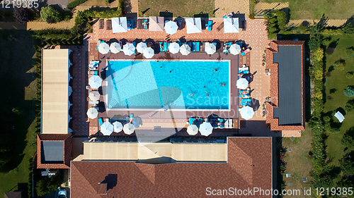 Image of Aerial view on people in swimming pool. Top view of people sunbathing pool.