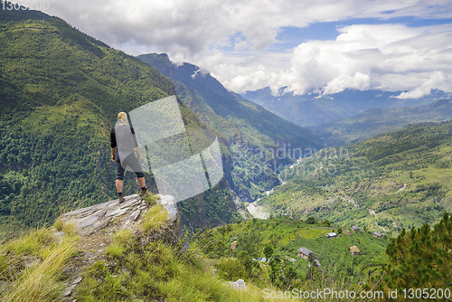 Image of Man standing on hill top in Himalayas
