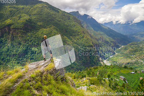 Image of Man standing on hill top in Himalayas