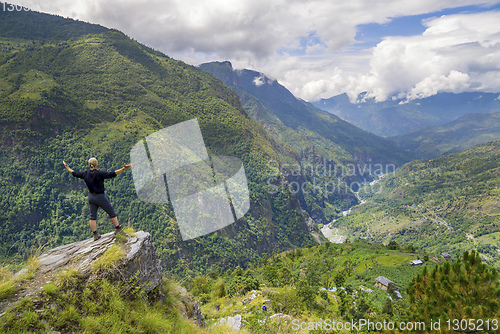 Image of Man standing on hill top in Himalayas