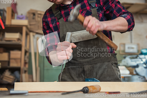 Image of Carpenter working with a chisel