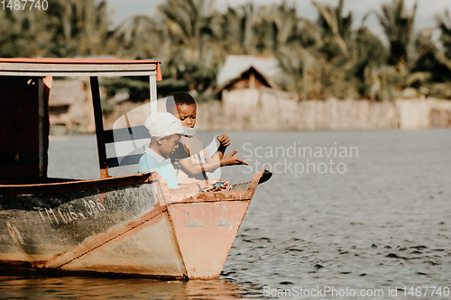 Image of Young boys catch fish with fishing line