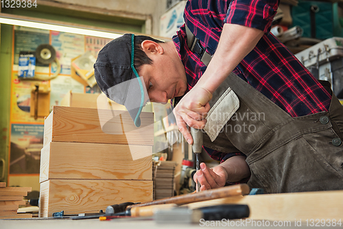 Image of Carpenter working with a chisel