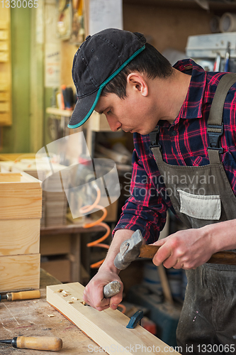 Image of Carpenter working with a chisel