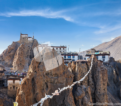 Image of Dhankar gompa (Tibetan Buddhist monastery) and prayer flags (lun