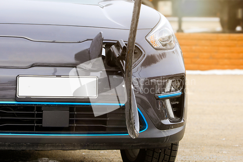 Image of Electric Vehicle Plugged in at Charging Station