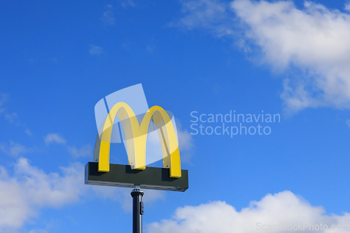 Image of McDonald's Logo Against Blue Sky and White Clouds