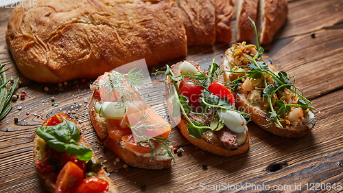 Image of Set of assorted bruschetta with various toppings for holiday. Top view. Party food concept.