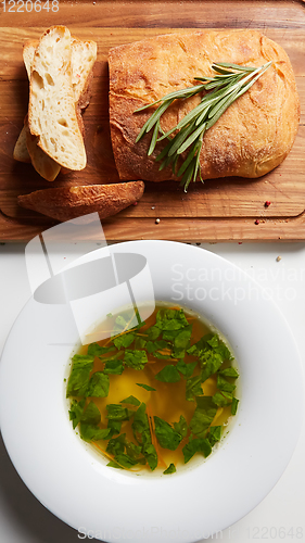 Image of Hot broth with ravioli and green onions. Studio Photo.