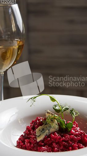 Image of Beetroot risotto with blue cheese on a white plate.