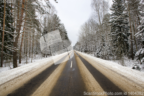 Image of details of the snow-covered road in forest