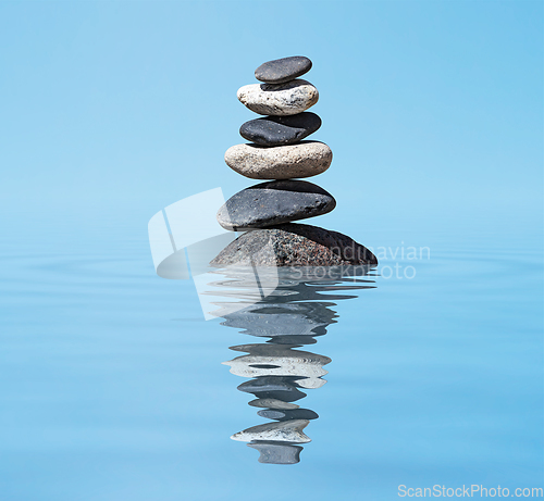 Image of Zen balanced stones stack in lake balance peace silence concept