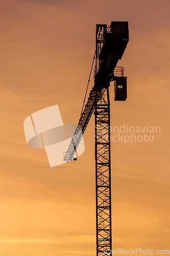 Image of Building crane silhouettes in sky