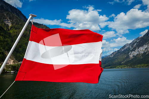 Image of Austrian flag agains mountain lake