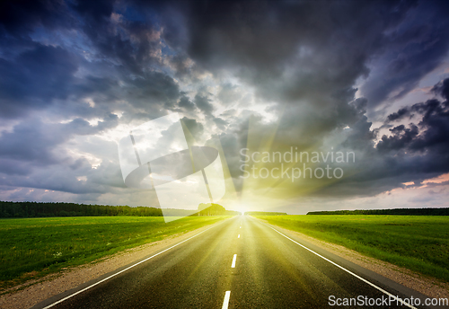 Image of Road and stormy sky on sunset