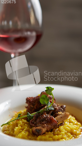 Image of The ossobuco and saffron risotto. Shallow dof