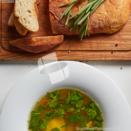 Image of Hot broth with ravioli and green onions. Studio Photo.