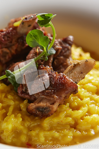 Image of The ossobuco and saffron risotto. Shallow dof