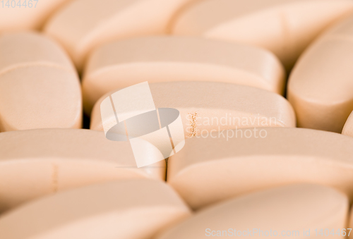 Image of convex light-colored pills