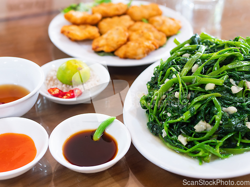 Image of rau muong xao toiietnamese food, rau muong xao toi and cha ca qu
