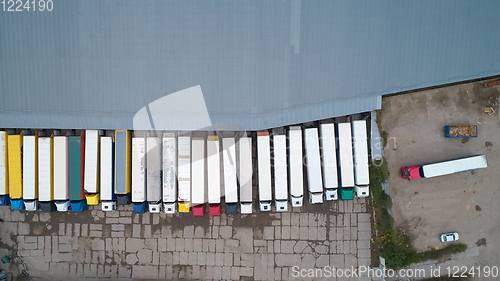 Image of Aerial view of goods warehouse. Logistics center in industrial city zone from above.