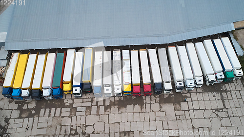 Image of Aerial view of goods warehouse. Logistics center in industrial city zone from above.