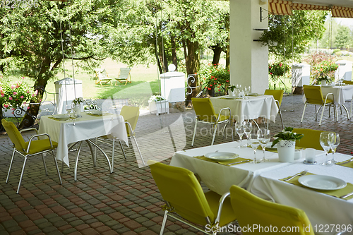 Image of terrace summer cafe with tables and chairs for people, an empty institution for recreation, nobody