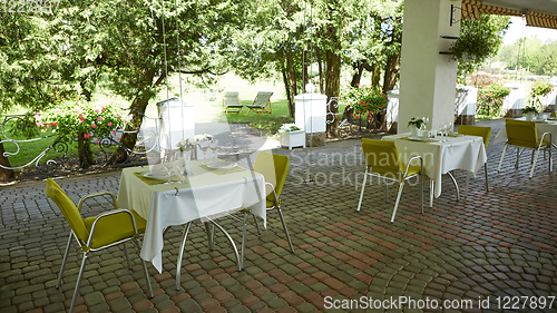 Image of terrace summer cafe with tables and chairs for people, an empty institution for recreation, nobody
