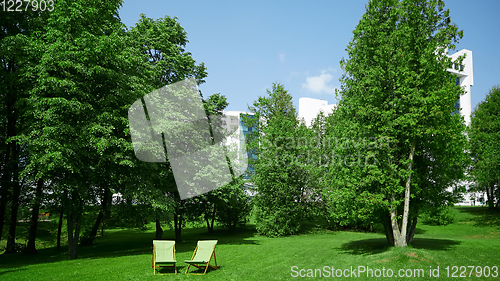 Image of Two resting chairs in the city park