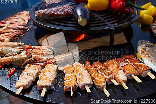 Image of Grilled fresh seafood: prawns, fish, octopus, oysters food background Barbecue Cooking BBQ