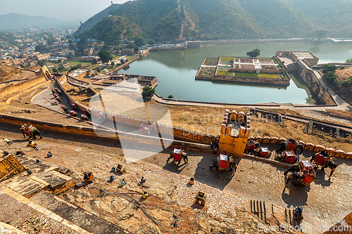 Image of Tourists riding elephants on ascend to Amer fort