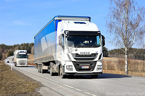 Image of Freight Transport by Two White Semi Trucks 