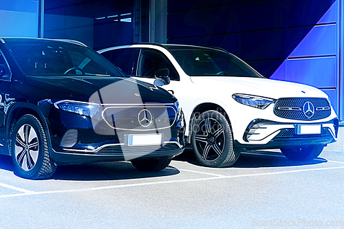 Image of Two New Luxury Mercedes-Benz SUV Cars in Blue Light