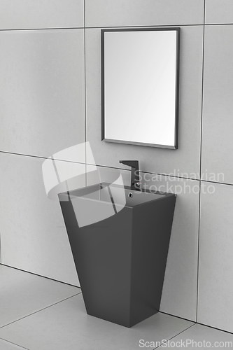 Image of Black wash basin with faucet and mirror
