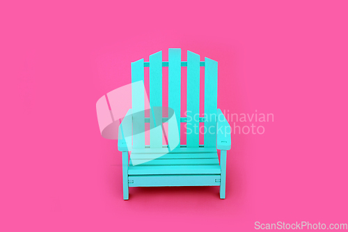 Image of Trendy Solitary Wooden Chair on Vivid Pink Background 