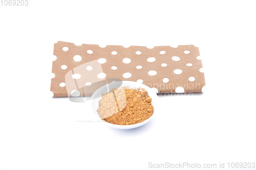 Image of Carob powder in bowl on white