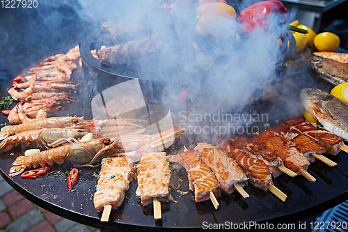 Image of Grilled fresh seafood: prawns, fish, octopus, oysters food background Barbecue Cooking BBQ
