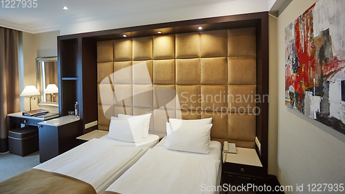 Image of Two beds in a hotel room. Interior design