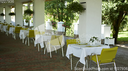 Image of terrace summer cafe with tables and chairs for people, an empty institution for recreation, nobody