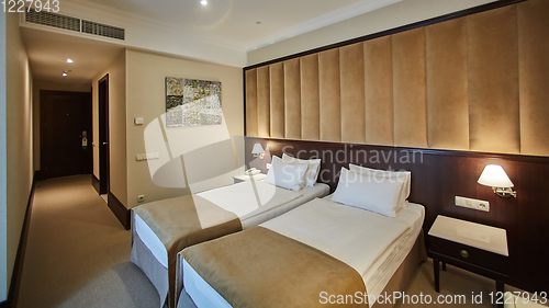 Image of Two beds in a hotel room. Interior design