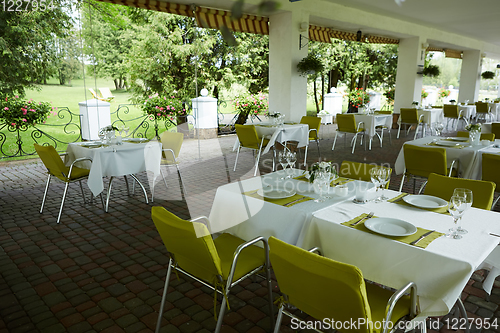 Image of terrace summer cafe with tables and chairs for people, an empty institution for recreation, nobody