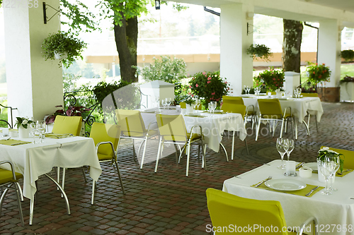 Image of terrace summer cafe with tables and chairs for people, an empty institution for recreation, nobody