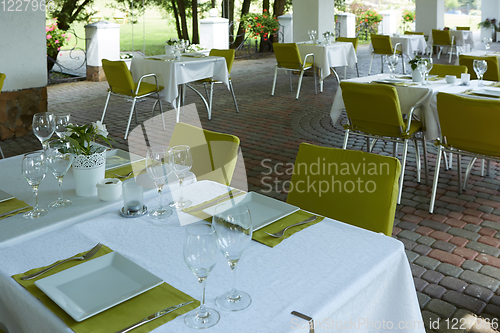 Image of terrace summer cafe with tables and chairs for people, an empty institution for recreation, nobody