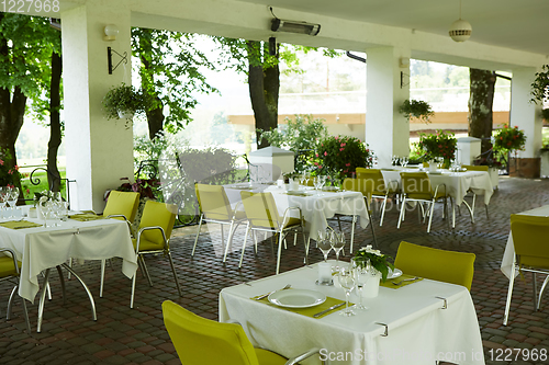 Image of terrace summer cafe with tables and chairs for people, an empty institution for recreation, nobody