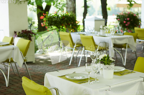 Image of terrace summer cafe with tables and chairs for people, an empty institution for recreation, nobody