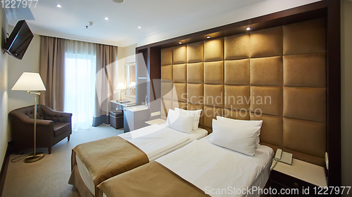 Image of Two beds in a hotel room. Interior design