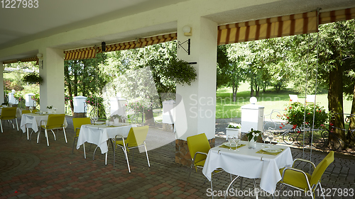 Image of terrace summer cafe with tables and chairs for people, an empty institution for recreation, nobody